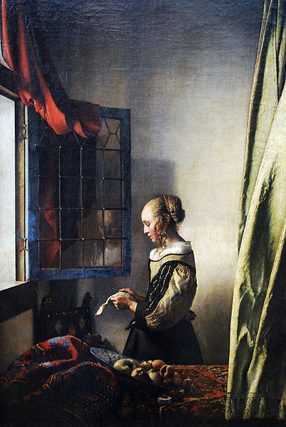 Girl reading a letter by an open window